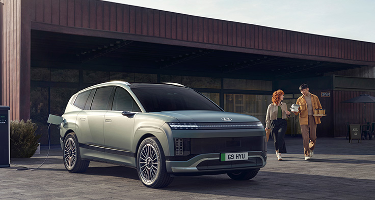 couple walking to car with coffees