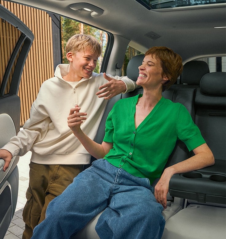 Big, bright and beautiful women and boy laughing.