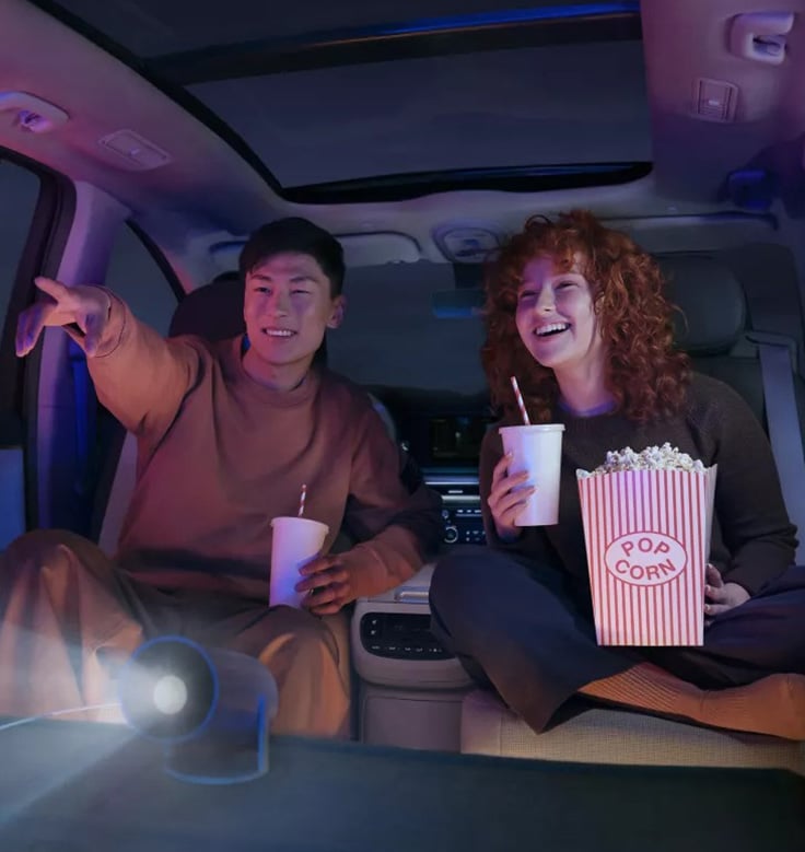 2nd row Swivelling Seats - couple watching a movie with popcorn.