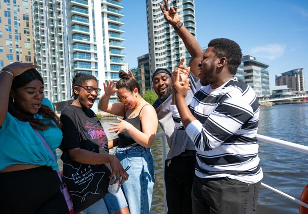 Test your detective skills in our mini car hunt A group of diverse people dancing together on a boat.