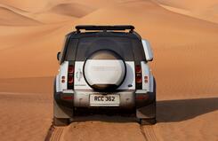 DEFENDER 110 rear view driving towards sand dunes