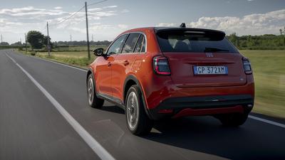 Orange Fiat 600e rear driving 